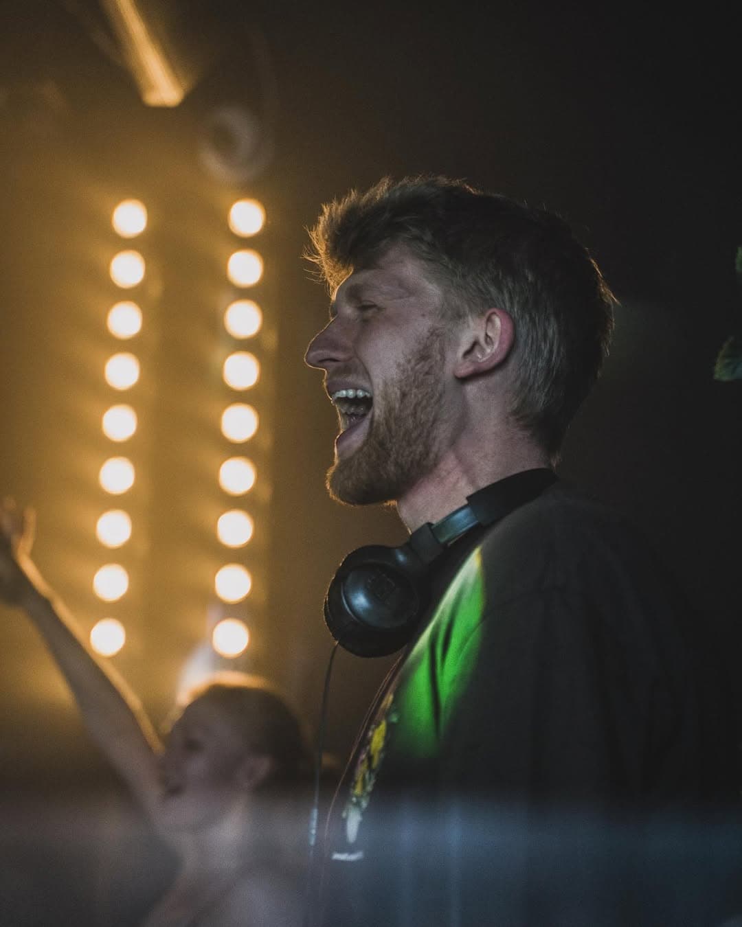 DJ Daku performing live with stage lighting